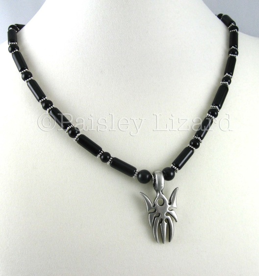 spidar pendant on black beaded necklace