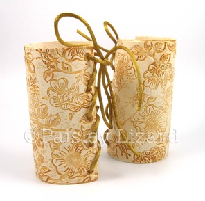 Gilded faux white leather archer cuffs