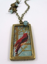 Resin encased collage pendant necklace