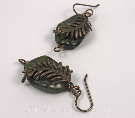 Picture of green beaded earrings with brass fern leaves