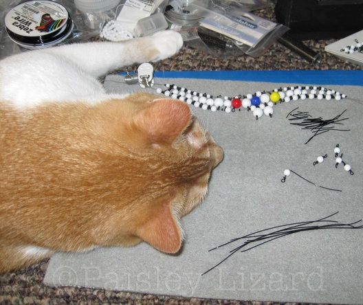 cat napping on bead mat