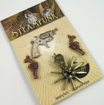 Picture of gun and spur charms in package