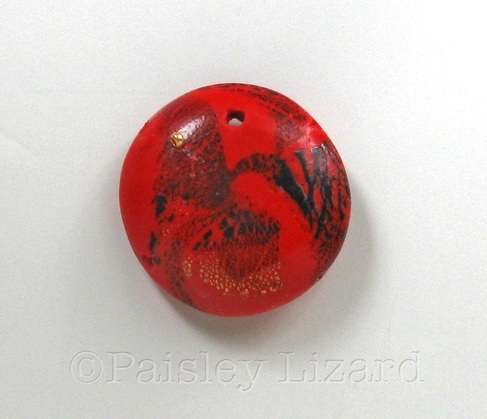 Picture of polymer clay bead with seed bead in hole