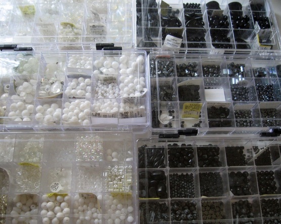 Picture of black and white beads in storage containers