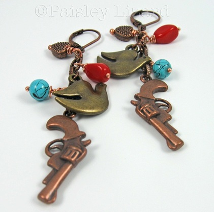Picture of earrings with doves, hearts, and gun charms