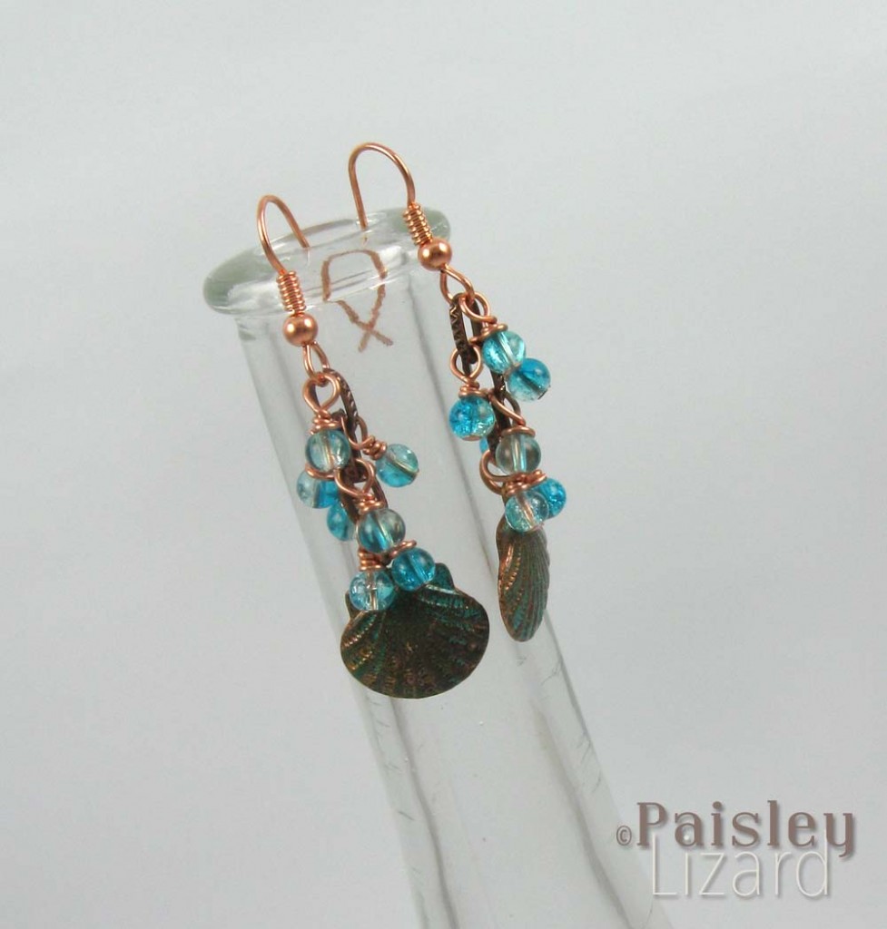 Scallop shell dangle earrings on vase