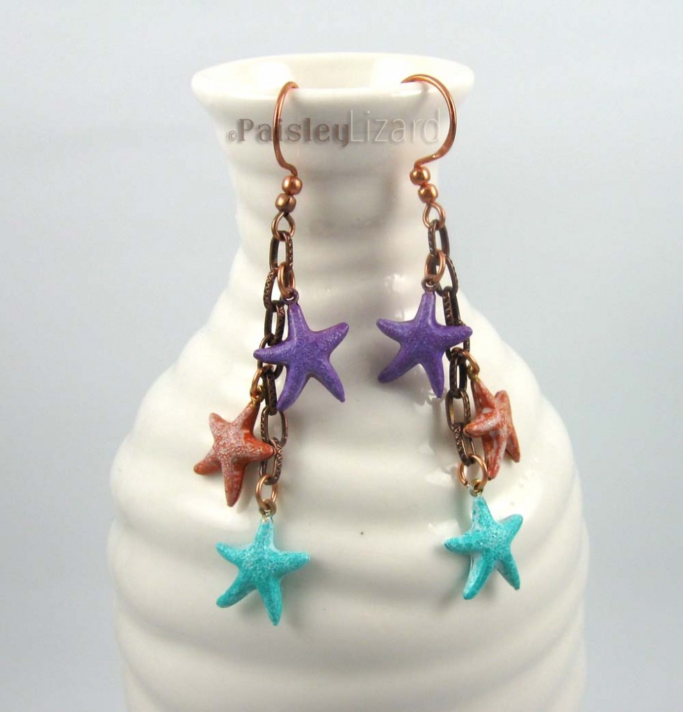 Pastel starfish dangle earrings on bottle