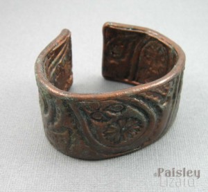 Stamped copper cuff with patina