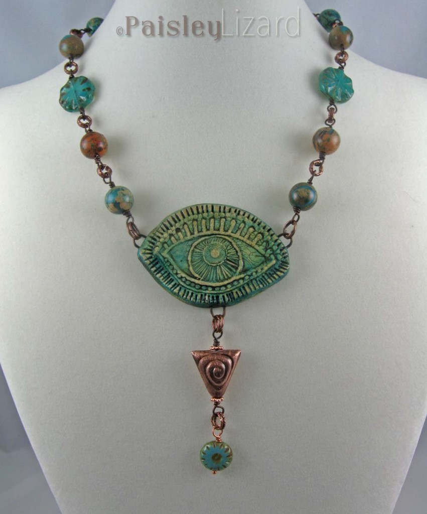 Green Evil eye necklace shown hanging