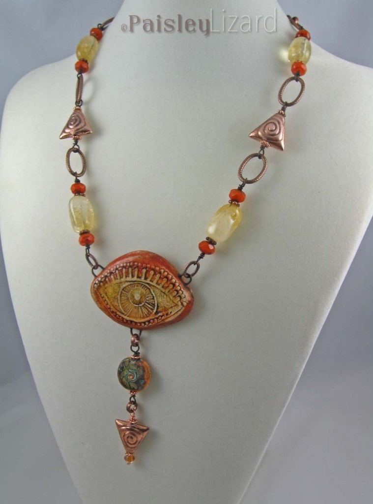 Orange Evil Eye necklace shown hanging