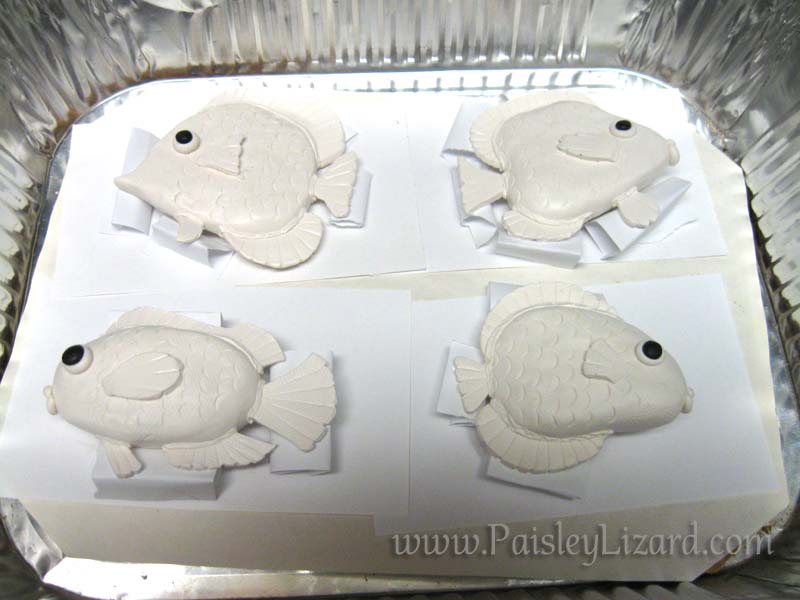 Four polymer clay fish in baking pan