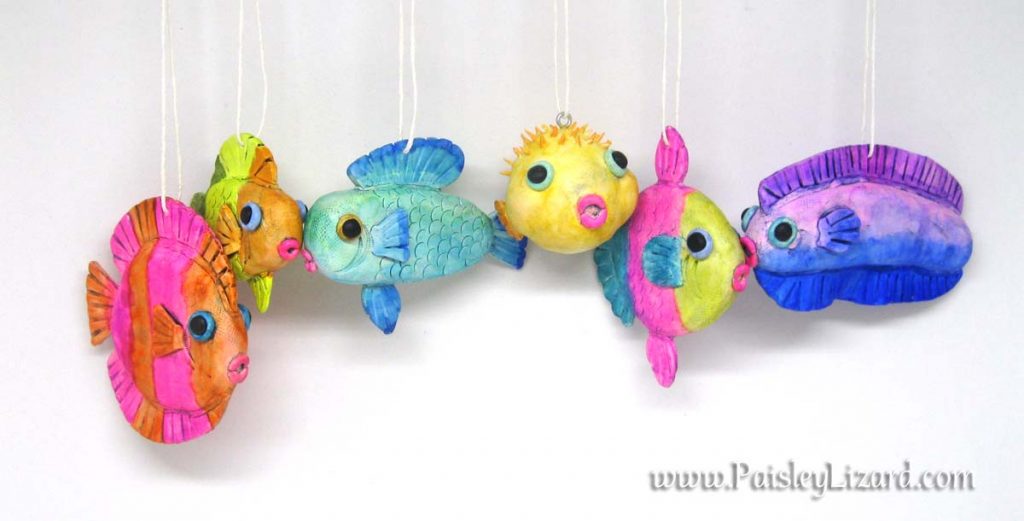 Six fish ornaments hanging on string