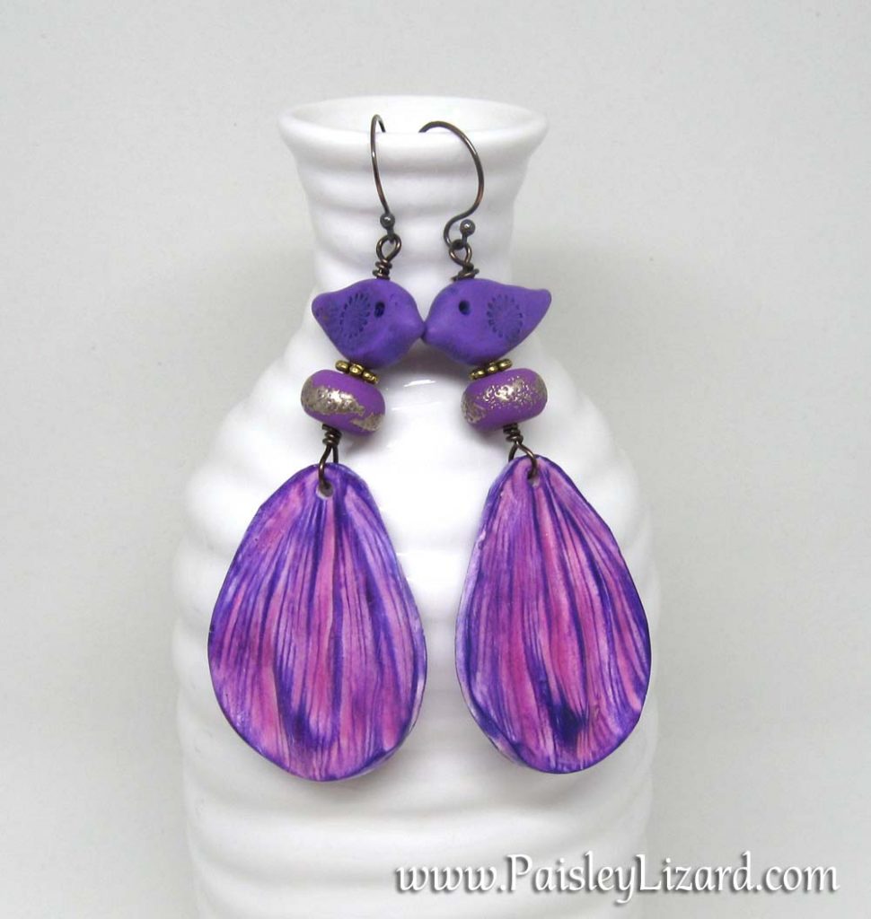 Purple bird and flower petal statement earrings