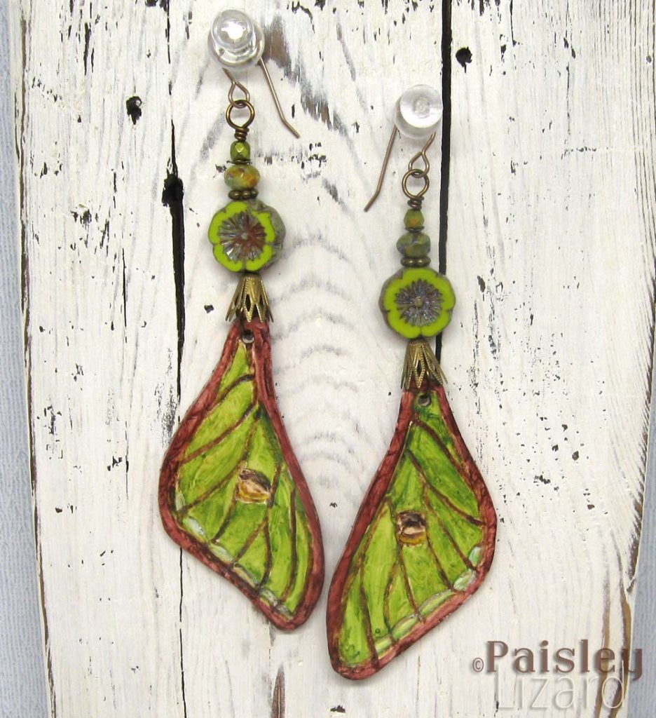 Luna moth forewing earrings on whitewash wood display