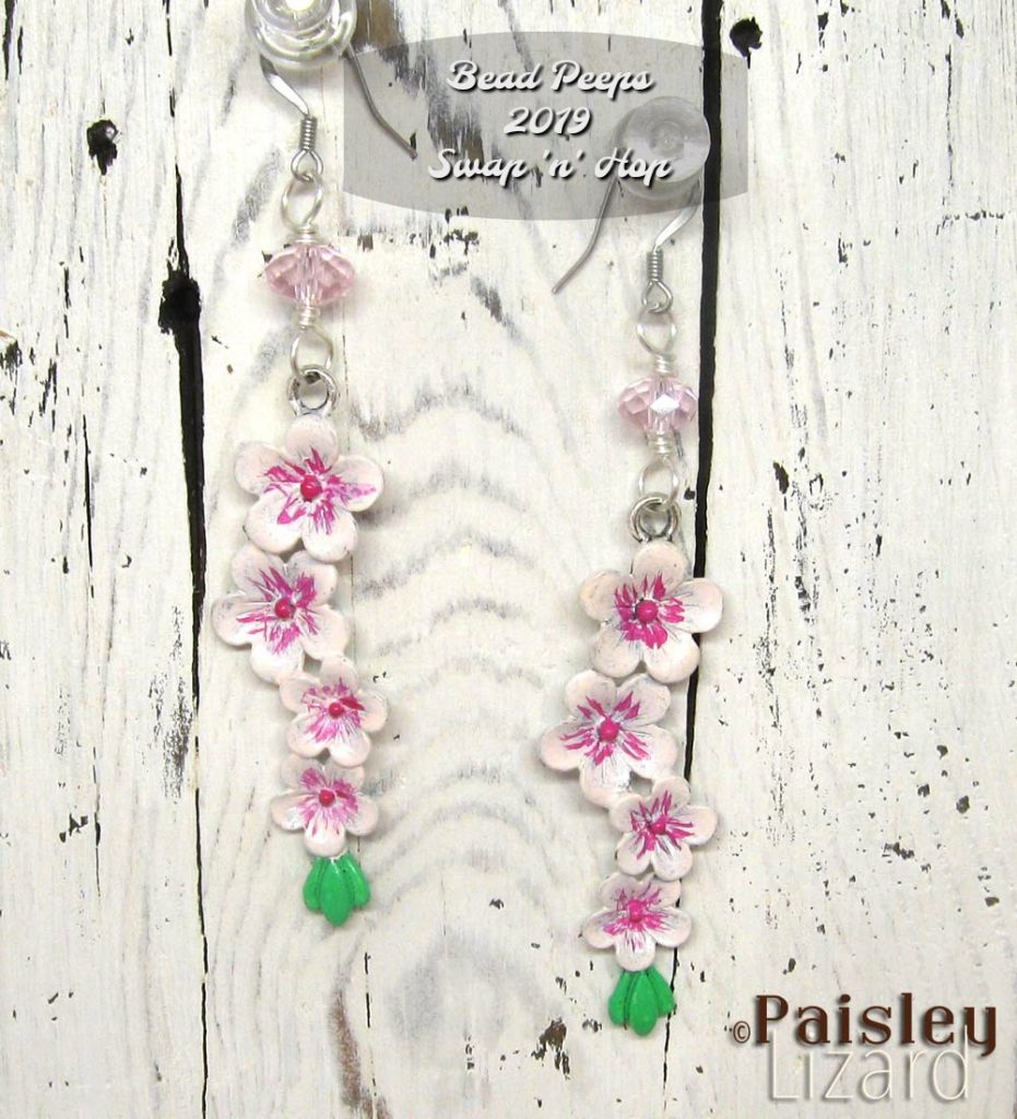 Cherry blossom dangle earrings on whitewash wood