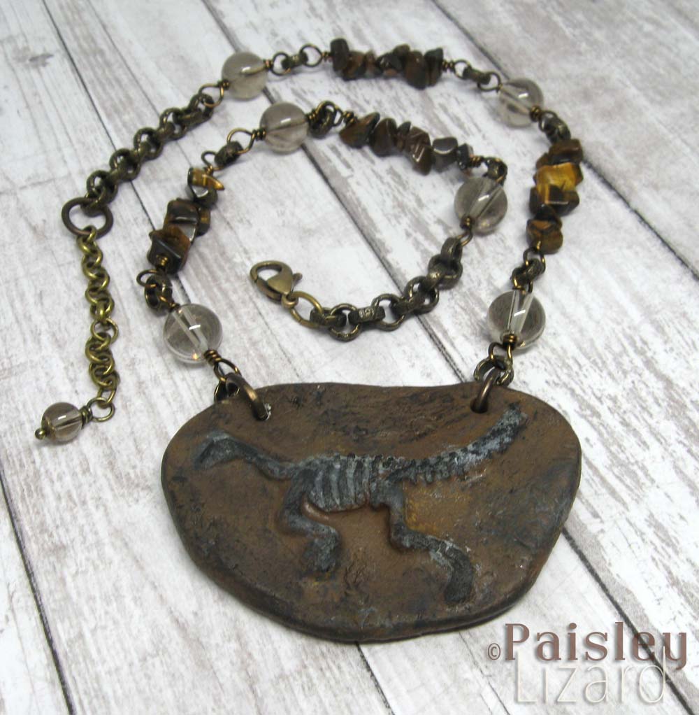 Faux fossil lizard necklace on beaded chain.