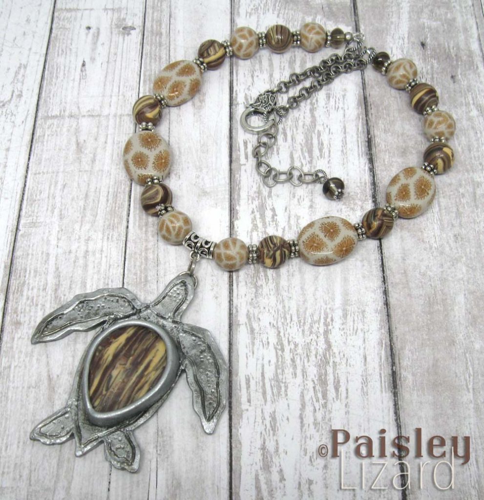 Sea turtle pendant necklace with faux fossil beads.