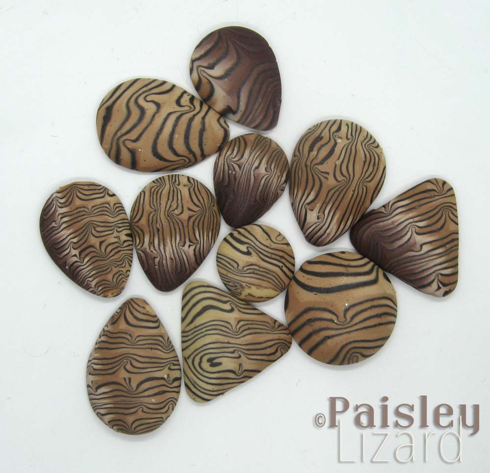 Faux petrified wood cabochons made from polymer clay veneer.