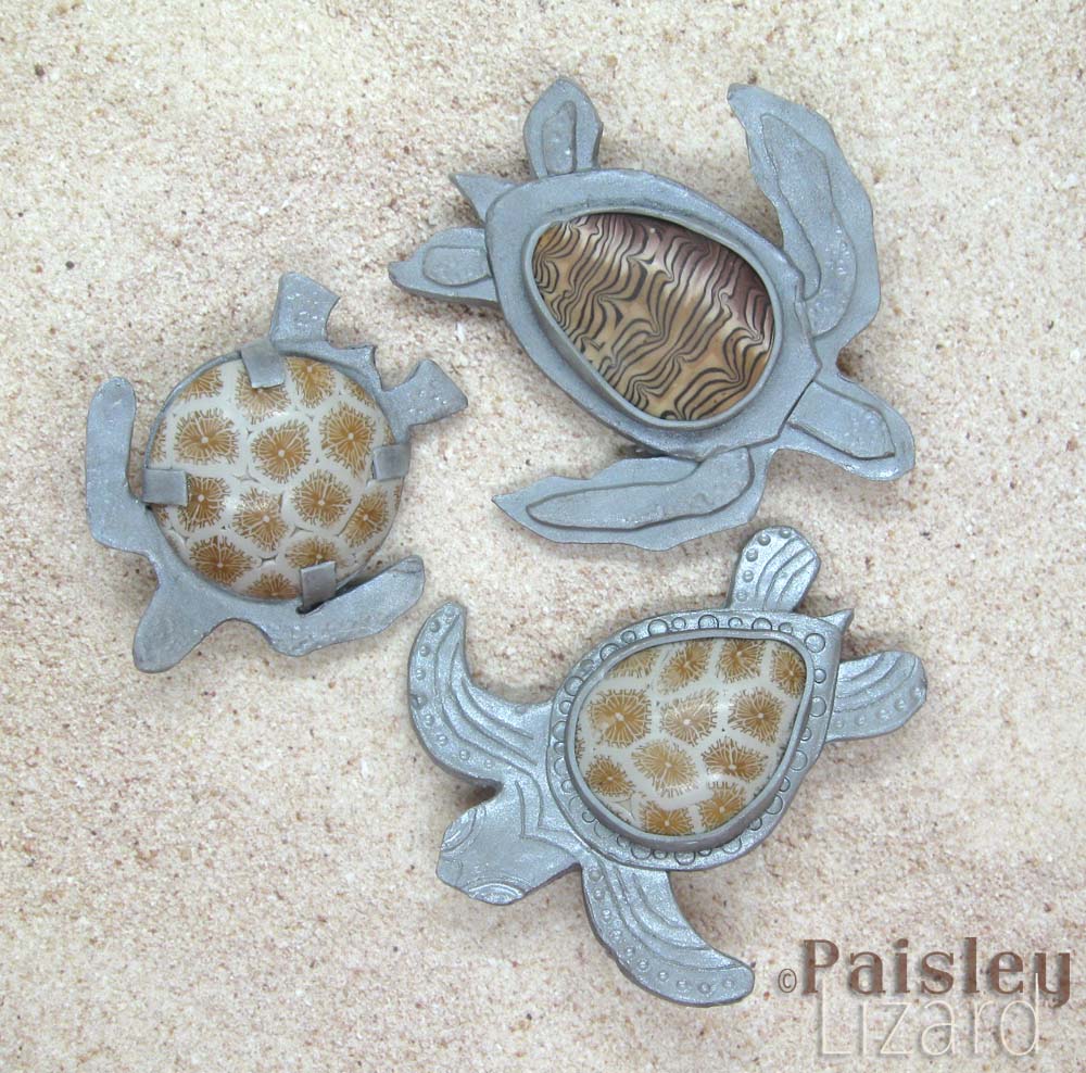 Three sea turtle brooches made with polymer clay.