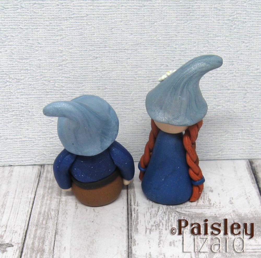 Polymer clay ginger gnome couple figurines from back view