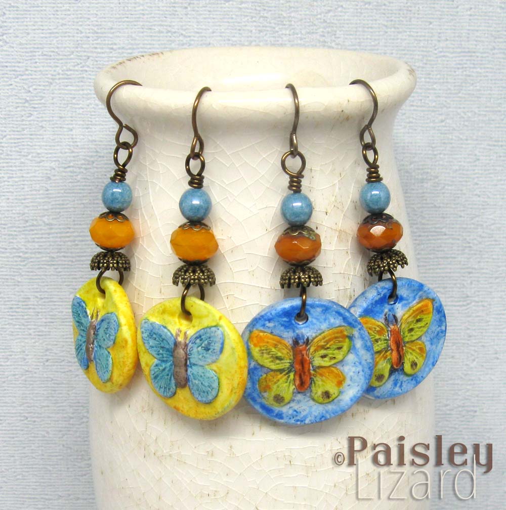 Two pairs of painted butterfly charm dangle earrings